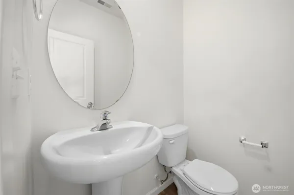 a white toilet sitting next to a bathroom sink