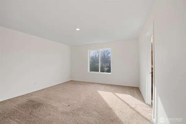 an empty room with a empty space and windows