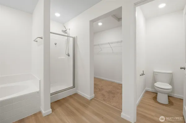 a bathroom view of a bathtub and a toilet