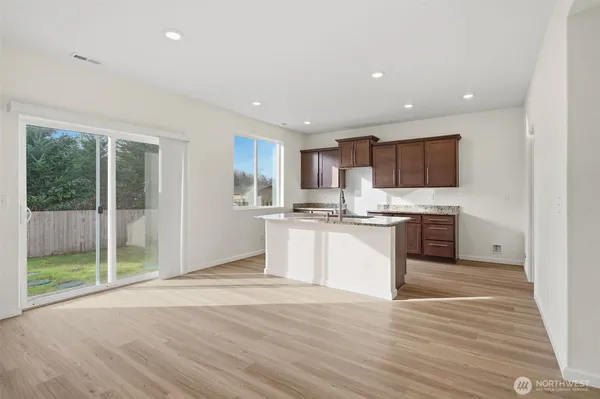 a kitchen with a refrigerator and a stove top oven