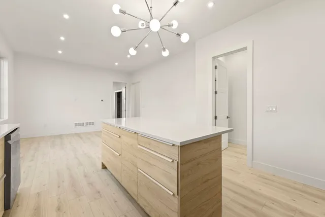 a bathroom with a sink a large mirror and shower