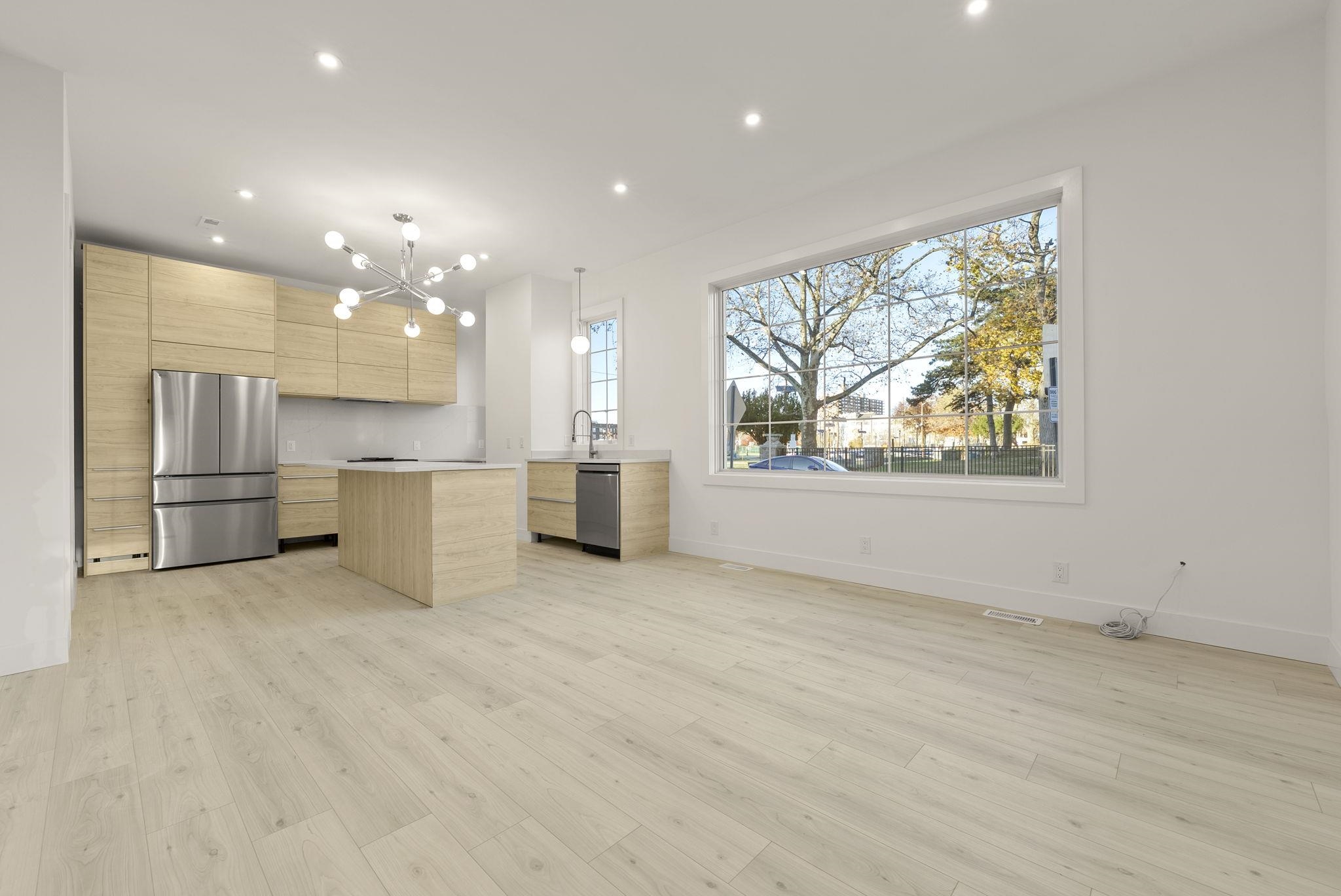 317 Sherman Avenue, Unit 1 Jersey City, NJ 07307 - Photo 3 of 29 a view of kitchen with stainless steel appliances kitchen island a stove a refrigerator a sink dishwasher with a dining table and chairs