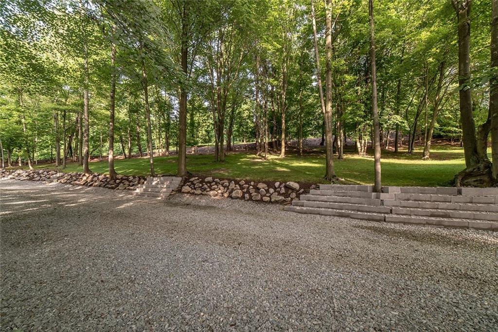 425 Marguerite Road Latrobe, PA 15650 - Photo 22 of 25 MANICURED LAWN AREA, EXTRA WIDE DRIVEWAY WITH ENGINEERED WALL AND SUBTERRANEAN DRAINAGE