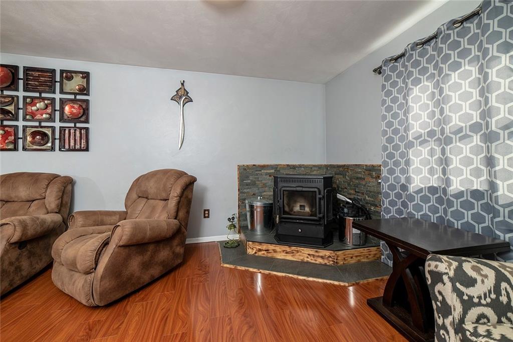 425 Marguerite Road Latrobe, PA 15650 - Photo 4 of 25 FAMILY ROOM WITH 4 FUEL STOVE FOR AUXILLARY HEAT IN WINTER. PROFESSIONALLY INSTALLED WITH SLATE AND STONE HEARTH AND WALL TREATMENT.
