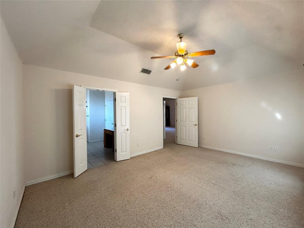 501 South Old Betsy Road, Unit 28 Keene, TX 76059 - Photo 7 of 10 an empty room with closet and a chandelier fan