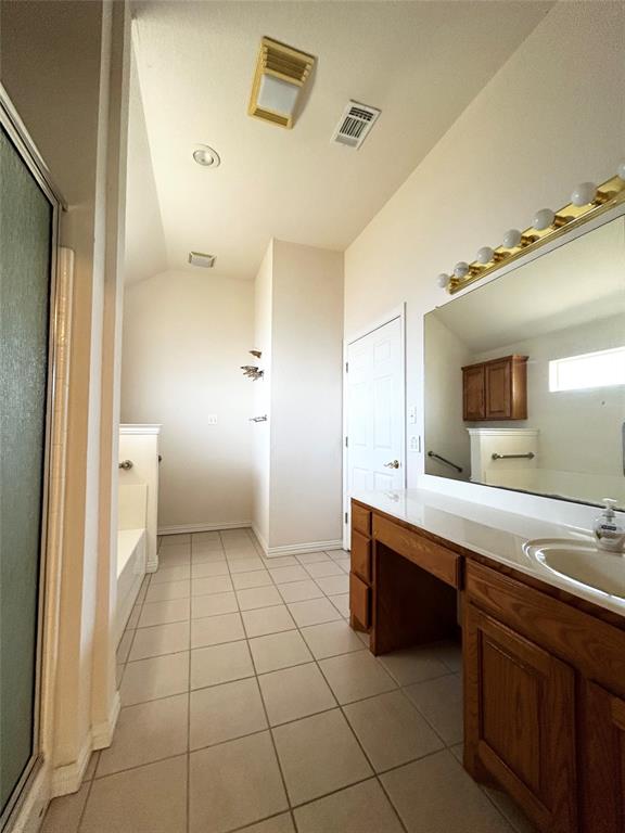 501 South Old Betsy Road, Unit 28 Keene, TX 76059 - Photo 9 of 10 a spacious bathroom with a granite countertop sink a mirror and a toilet