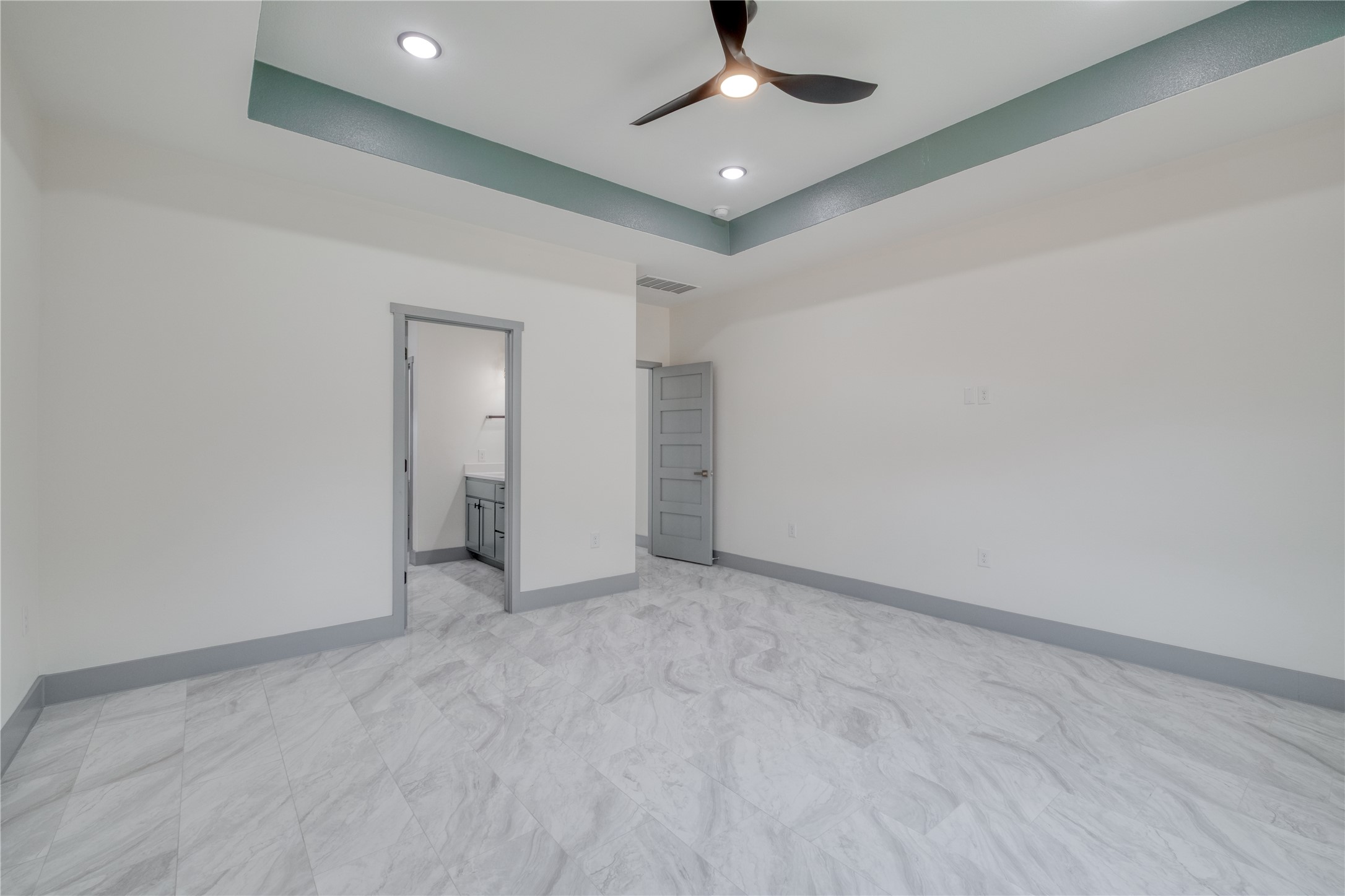 204 Washington Street Elgin, TX 78621 - Photo 10 of 24 an empty room with a ceiling fan and carpet