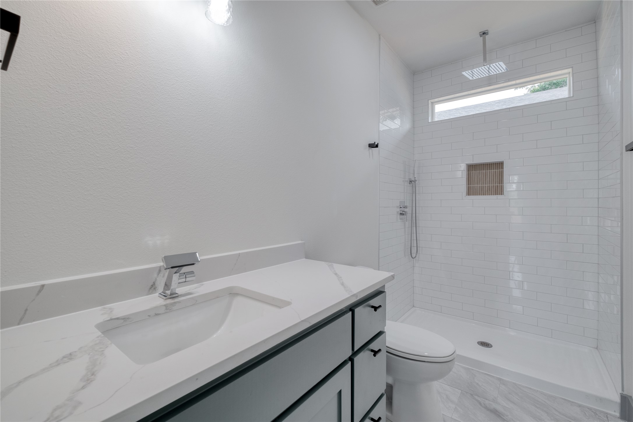 204 Washington Street Elgin, TX 78621 - Photo 18 of 24 a bathroom with a sink toilet and shower