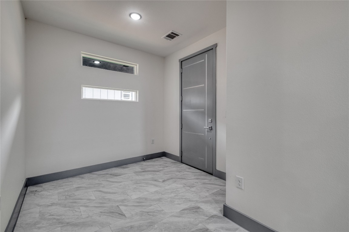204 Washington Street Elgin, TX 78621 - Photo 19 of 24 Open entryway with transom windows