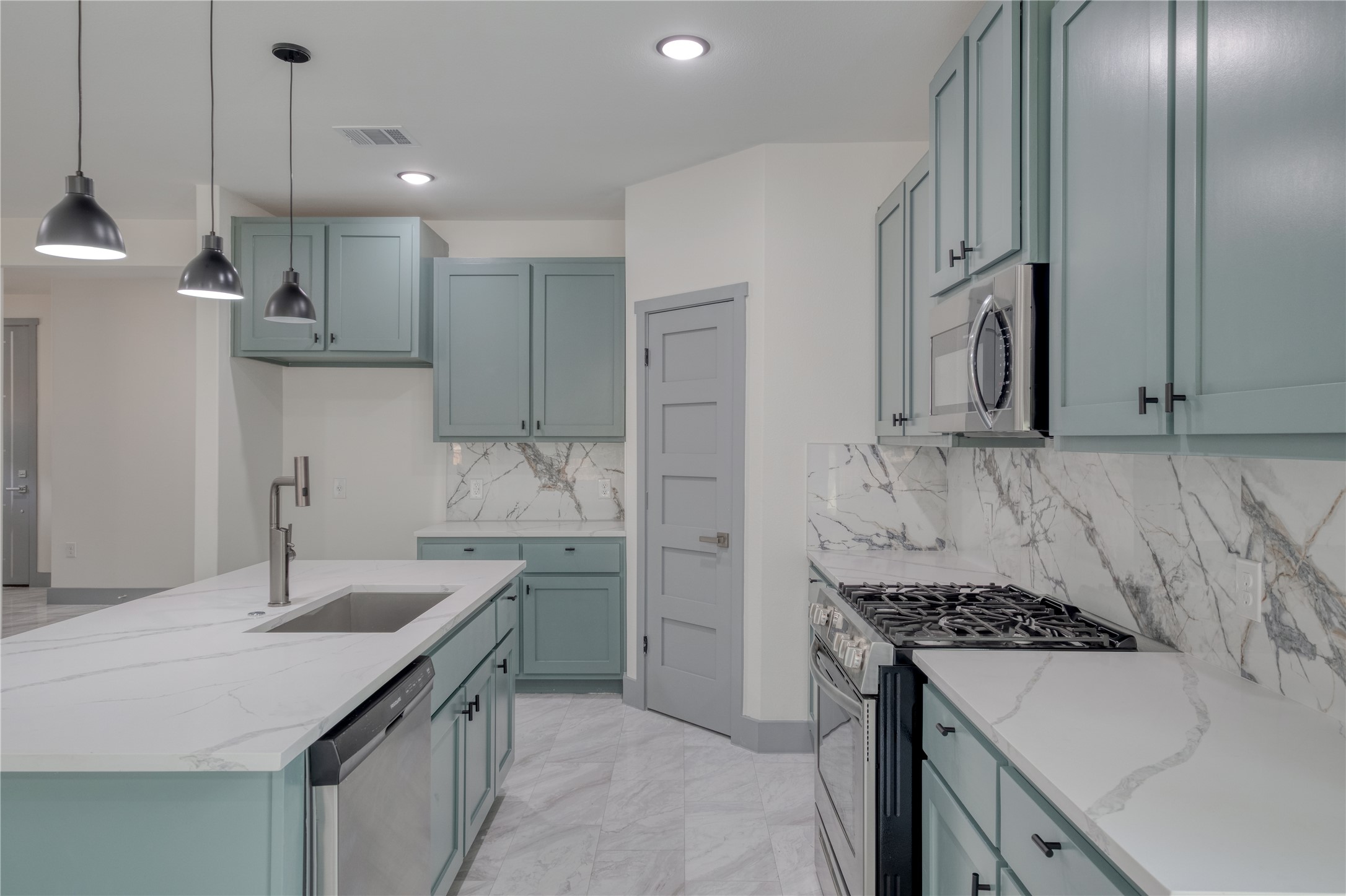 204 Washington Street Elgin, TX 78621 - Photo 5 of 24 a kitchen with a sink stove and refrigerator