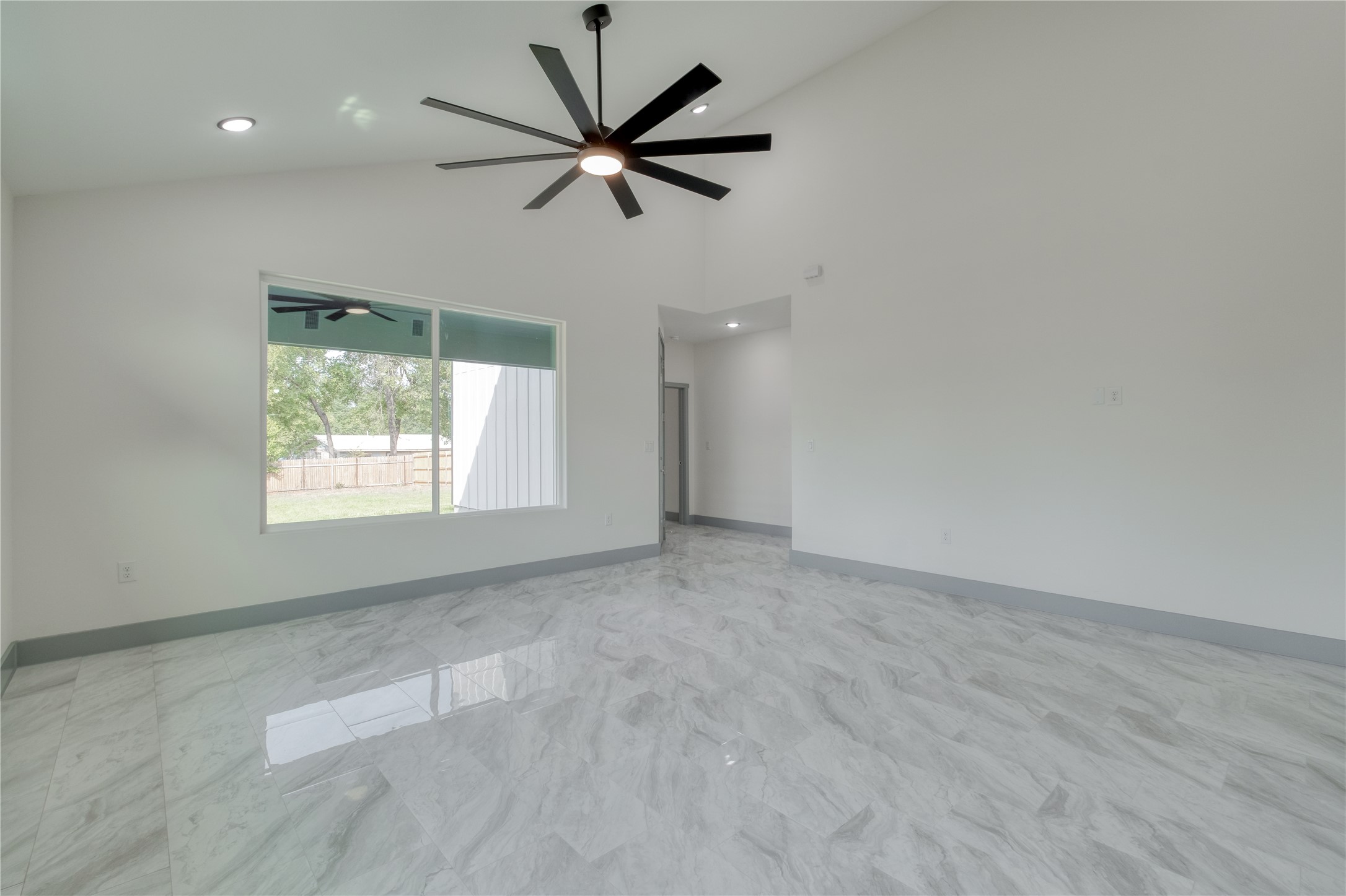 204 Washington Street Elgin, TX 78621 - Photo 8 of 24 an empty room with a window and a fan