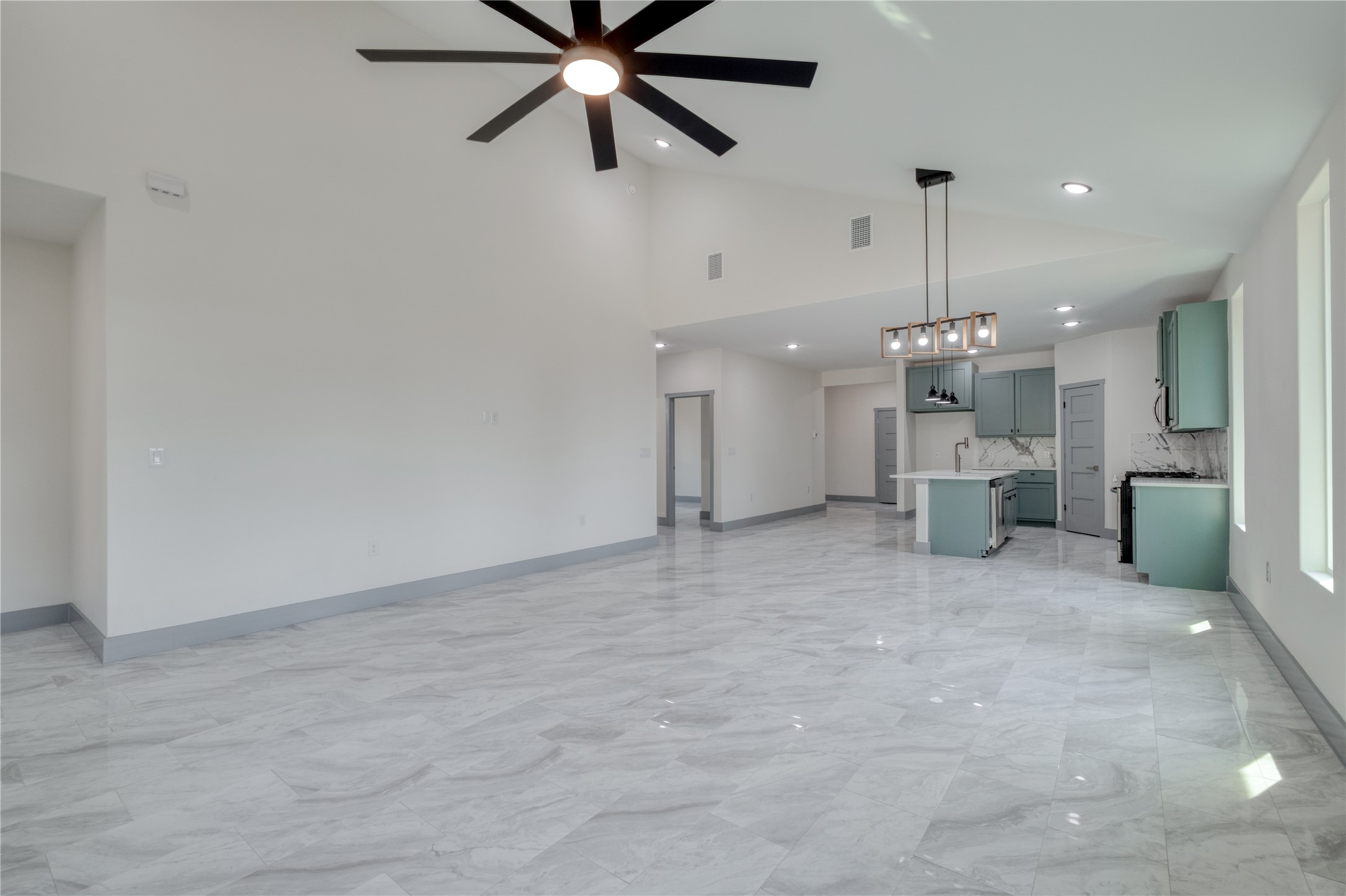 204 Washington Street Elgin, TX 78621 - Photo 24 of 24 a view of a big room with a ceiling fan and a window