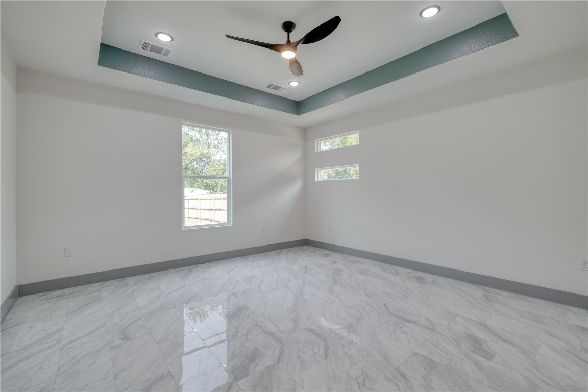 204 Washington Street Elgin, TX 78621 - Photo 9 of 24 Primary bedroom accents match cupboards and accents around the house