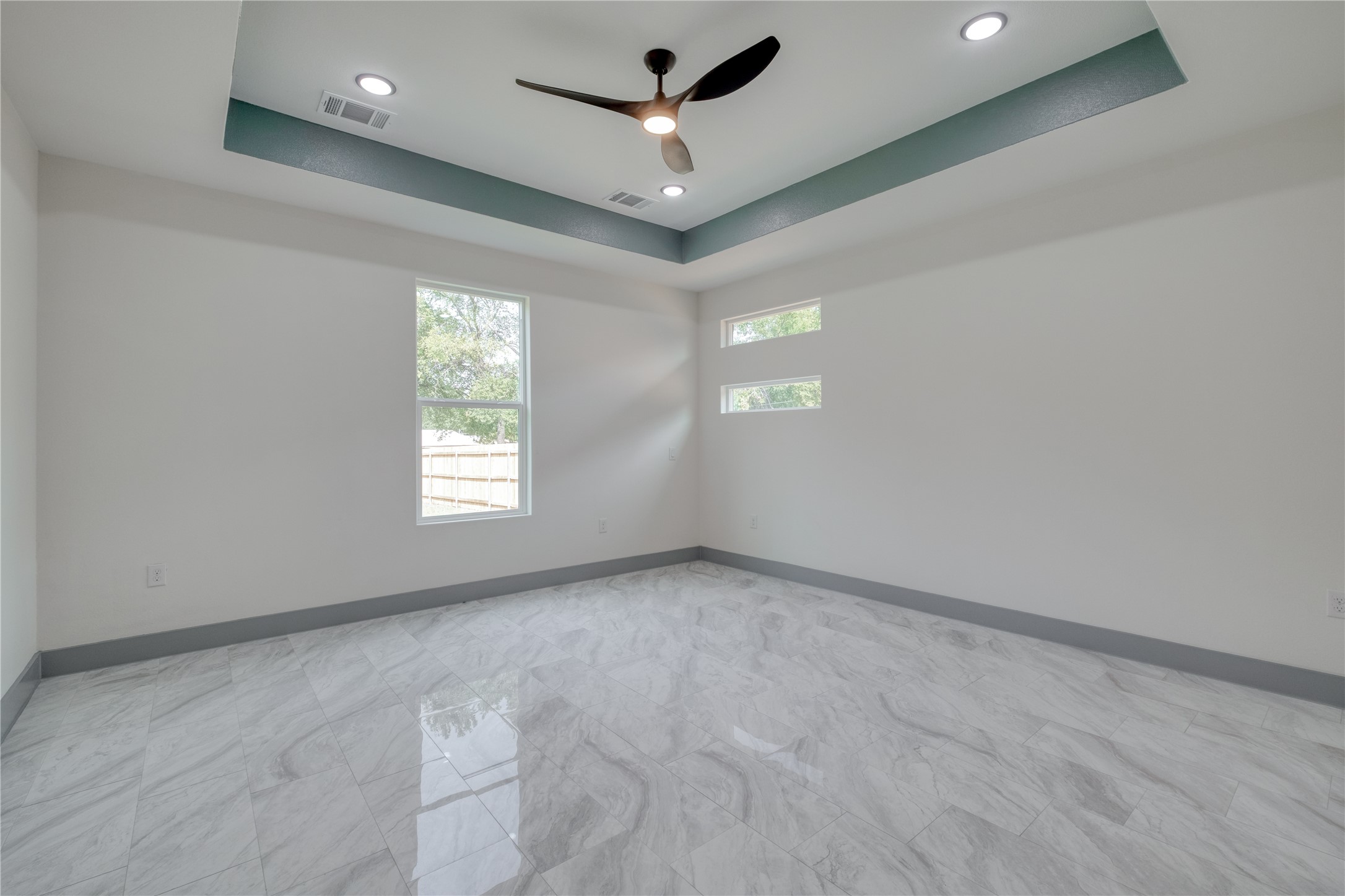 204 Washington Street Elgin, TX 78621 - Photo 9 of 24 an empty room with a window and a ceiling fan