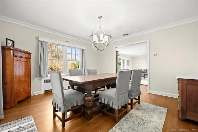 a view of a dining room with furniture window and wooden floor