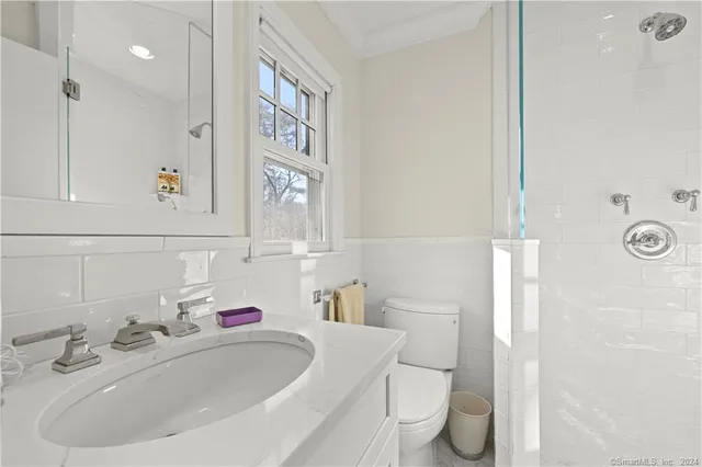 a bathroom with a sink a toilet and shower curtain