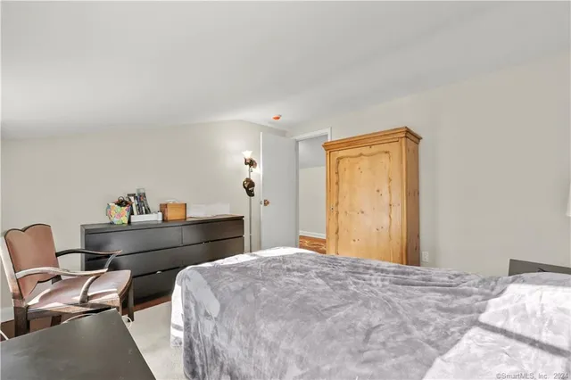 a bed room with a bed and chair