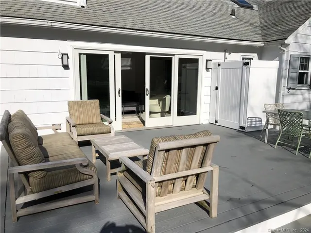 a roof deck with table and chairs