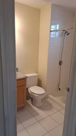 a bathroom with a toilet and a shower