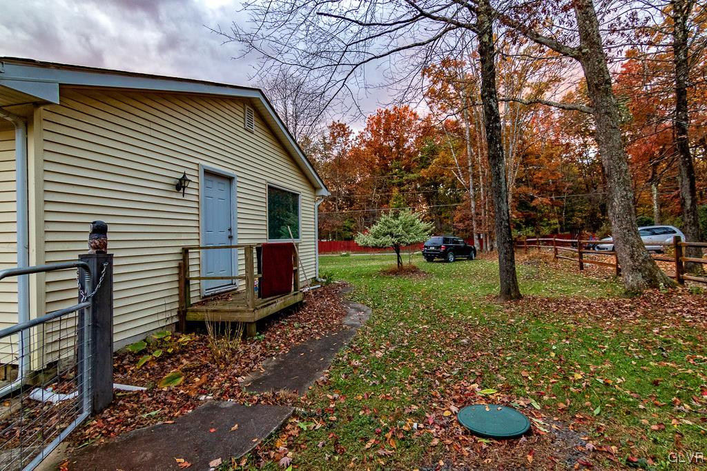 1907 Upper Valley Road Effort, PA 18330 - Photo 18 of 38 a view of a backyard with chairs potted plants and large tree