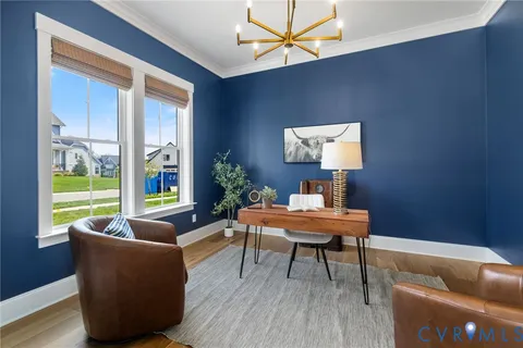 a living room with furniture kitchen view and a large window