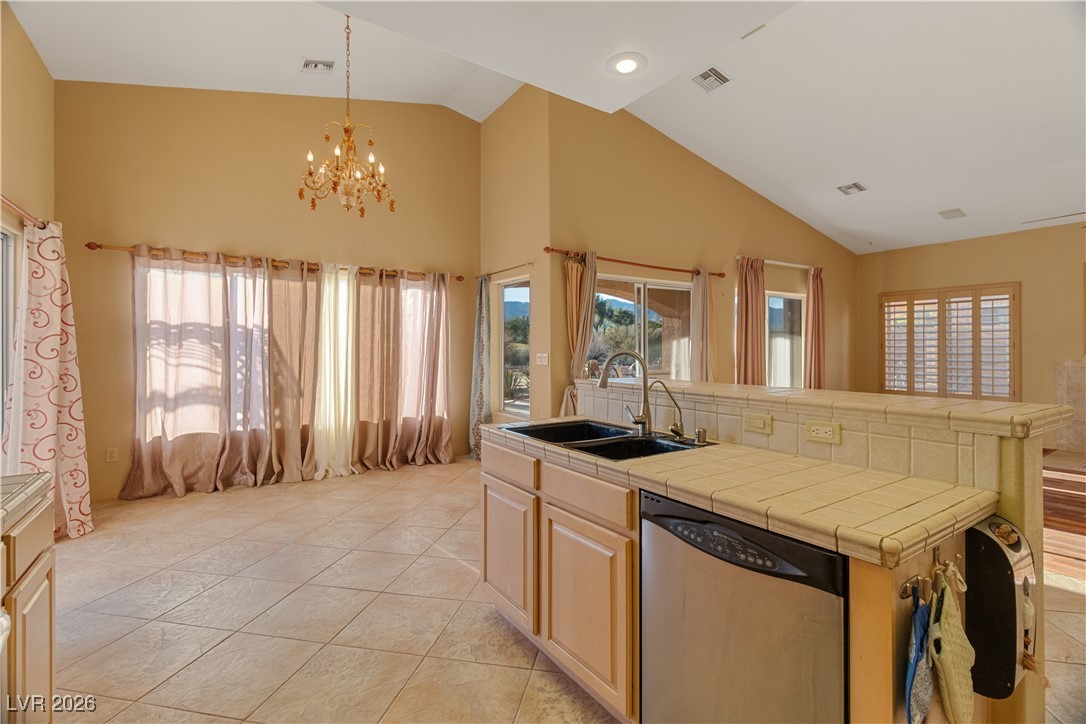 1210 Country Club Drive Laughlin, NV 89029 - Photo 14 of 80 Kitchen featuring tile countertops, high vaulted ceiling, dishwasher, and plenty of natural light