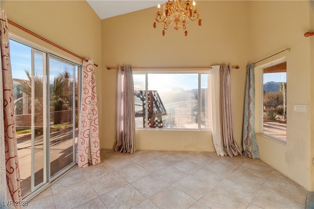 1210 Country Club Drive Laughlin, NV 89029 - Photo 15 of 80 Dining area with healthy amount of natural light, a chandelier, and lofted ceiling