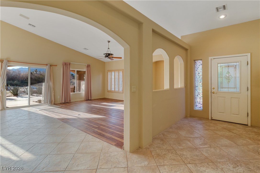 1210 Country Club Drive Laughlin, NV 89029 - Photo 2 of 80 Entrance foyer with arched walkways, light tile patterned flooring, a ceiling fan, vaulted ceiling, and recessed lighting