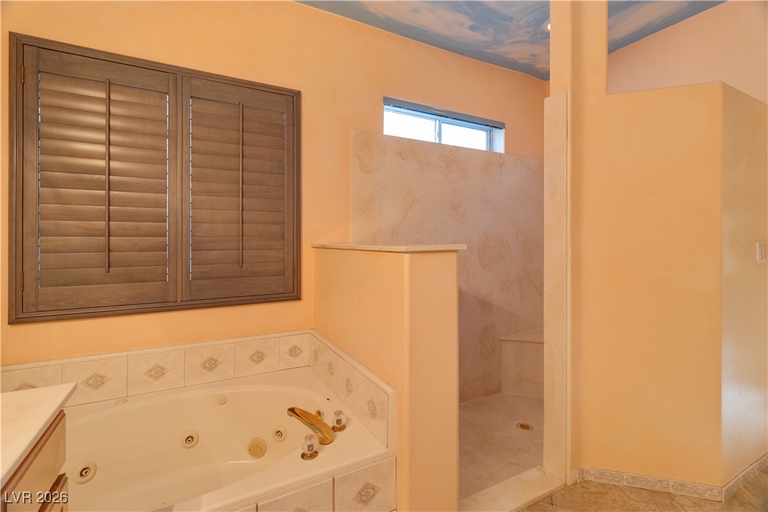 1210 Country Club Drive Laughlin, NV 89029 - Photo 23 of 80 Full Primary bath featuring a tub with jets, vanity, and walk in shower