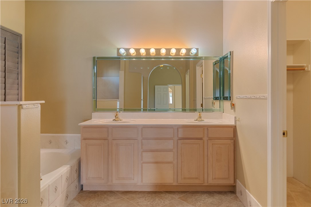 1210 Country Club Drive Laughlin, NV 89029 - Photo 30 of 80 Full Ensuite Secondary Bathroom featuring double vanity, a bath, and a spacious closet