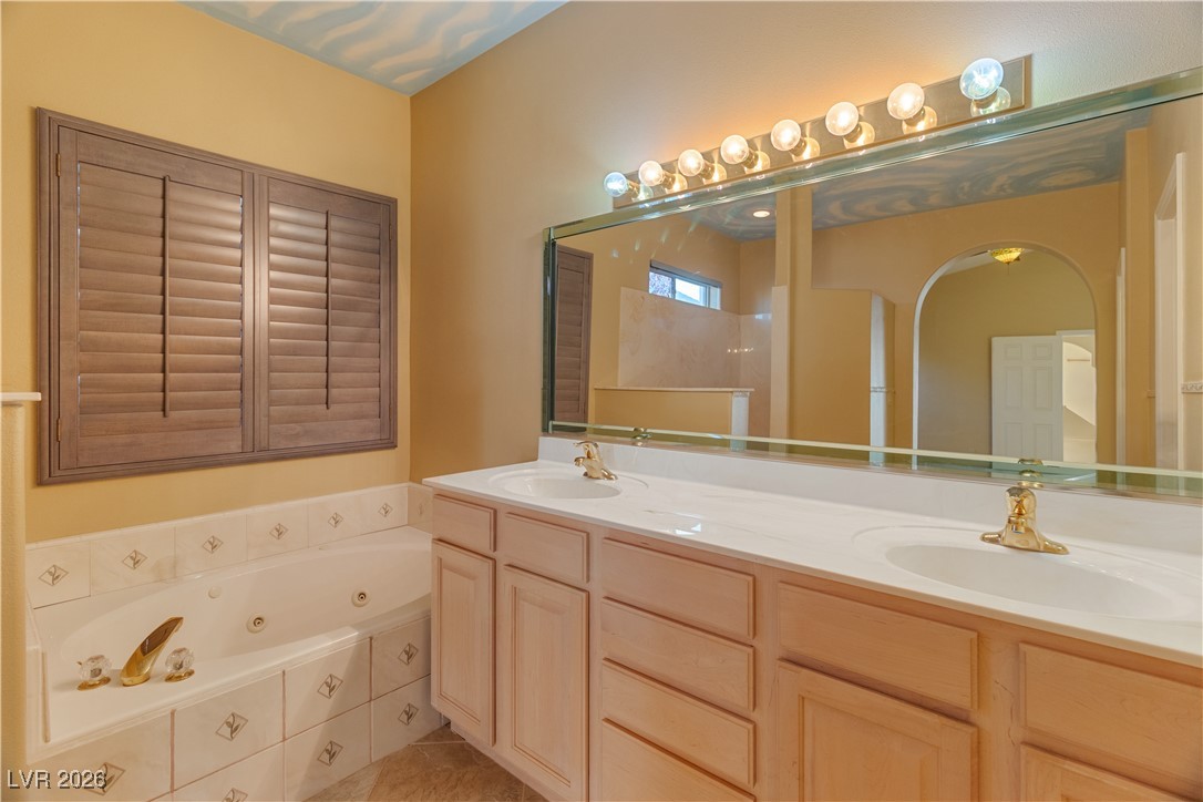 1210 Country Club Drive Laughlin, NV 89029 - Photo 31 of 80 Ensuite Secondary Bathroom with double vanity and a whirlpool tub
