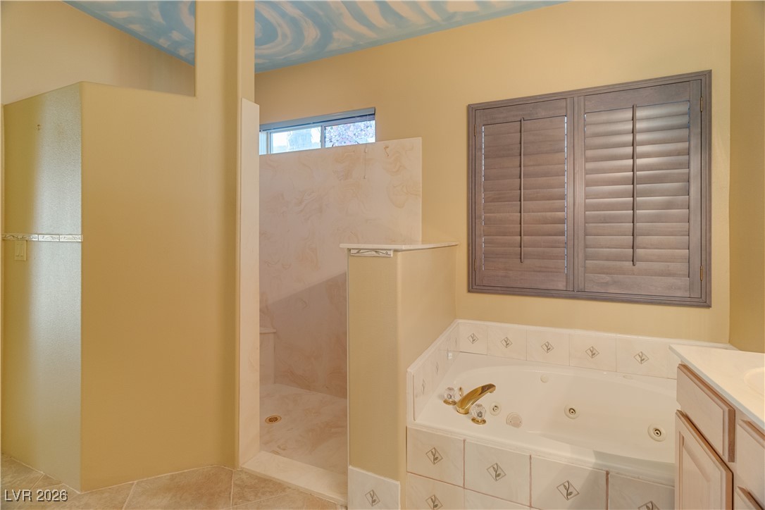 1210 Country Club Drive Laughlin, NV 89029 - Photo 32 of 80 Full Ensuite bath featuring vanity, a tub with jets, a marble finish shower, and tile patterned floors
