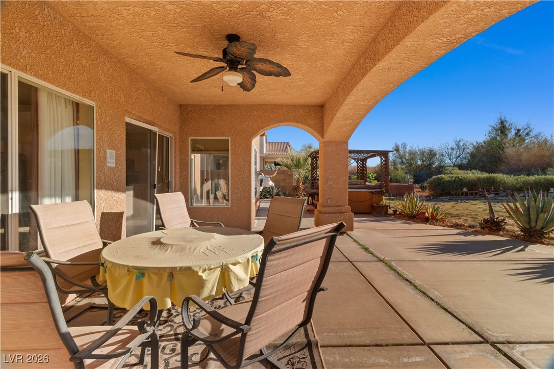 1210 Country Club Drive Laughlin, NV 89029 - Photo 50 of 80 View of back covered patio featuring ceiling fan, outdoor dining space, a hot tub, and a pergola