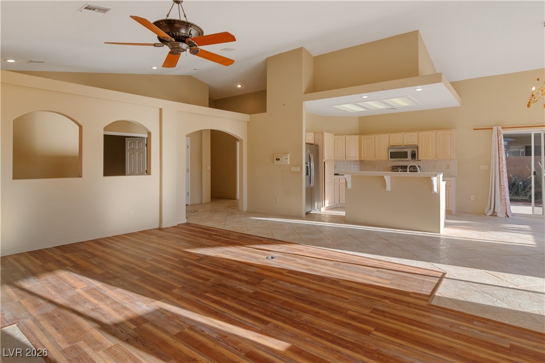 1210 Country Club Drive Laughlin, NV 89029 - Photo 5 of 80 Unfurnished living room with recessed lighting, light wood finished floors, arched walkways, and high vaulted ceiling