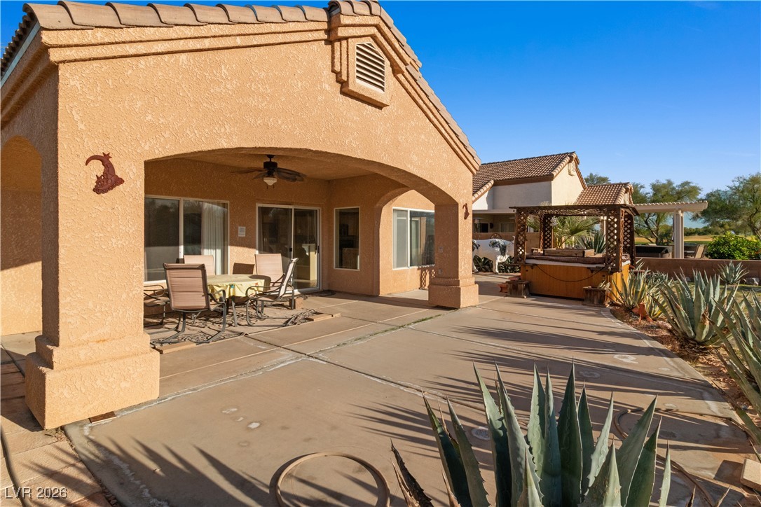 1210 Country Club Drive Laughlin, NV 89029 - Photo 56 of 80 View of patio featuring a hot tub, outdoor dining space, ceiling fan, and a pergola