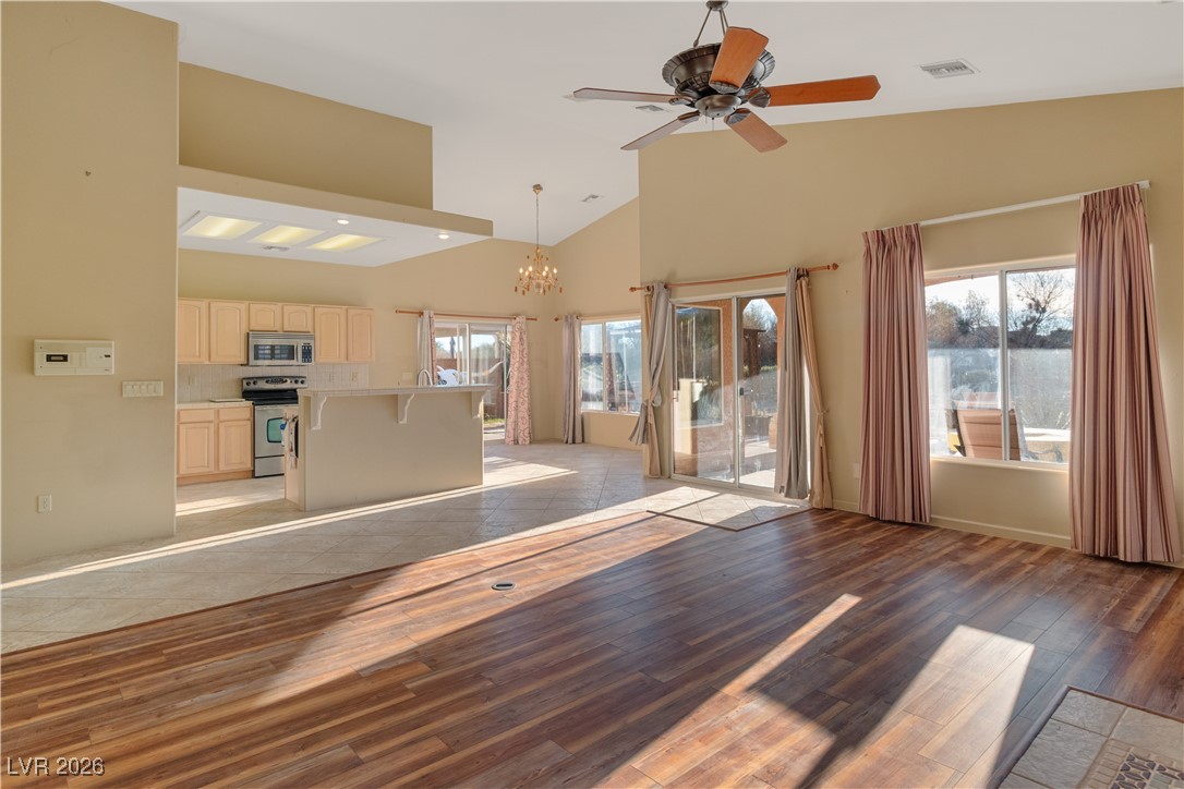 1210 Country Club Drive Laughlin, NV 89029 - Photo 6 of 80 Unfurnished living room featuring high vaulted ceiling, a chandelier, light wood-style flooring, and a ceiling fan