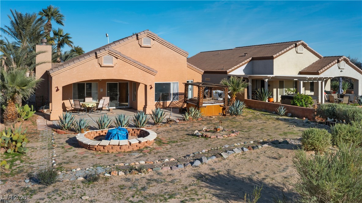 1210 Country Club Drive Laughlin, NV 89029 - Photo 62 of 80 Rear view of house featuring a patio, stucco siding, a tiled roof, and a chimney