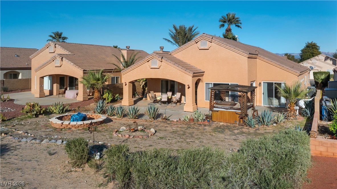 1210 Country Club Drive Laughlin, NV 89029 - Photo 63 of 80 Back of house with a patio, stucco siding, and a hot tub