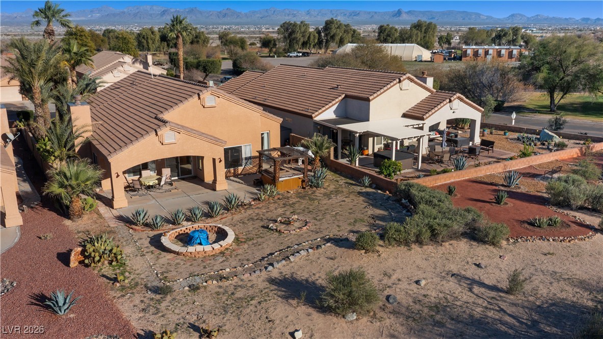 1210 Country Club Drive Laughlin, NV 89029 - Photo 66 of 80 Aerial view of the back of the home, with covered patio and yard