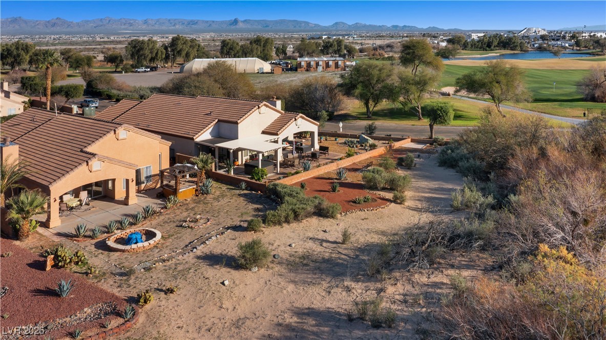 1210 Country Club Drive Laughlin, NV 89029 - Photo 67 of 80 Aerial view of the back of the home, with covered patio and yard with a mountainous backdrop