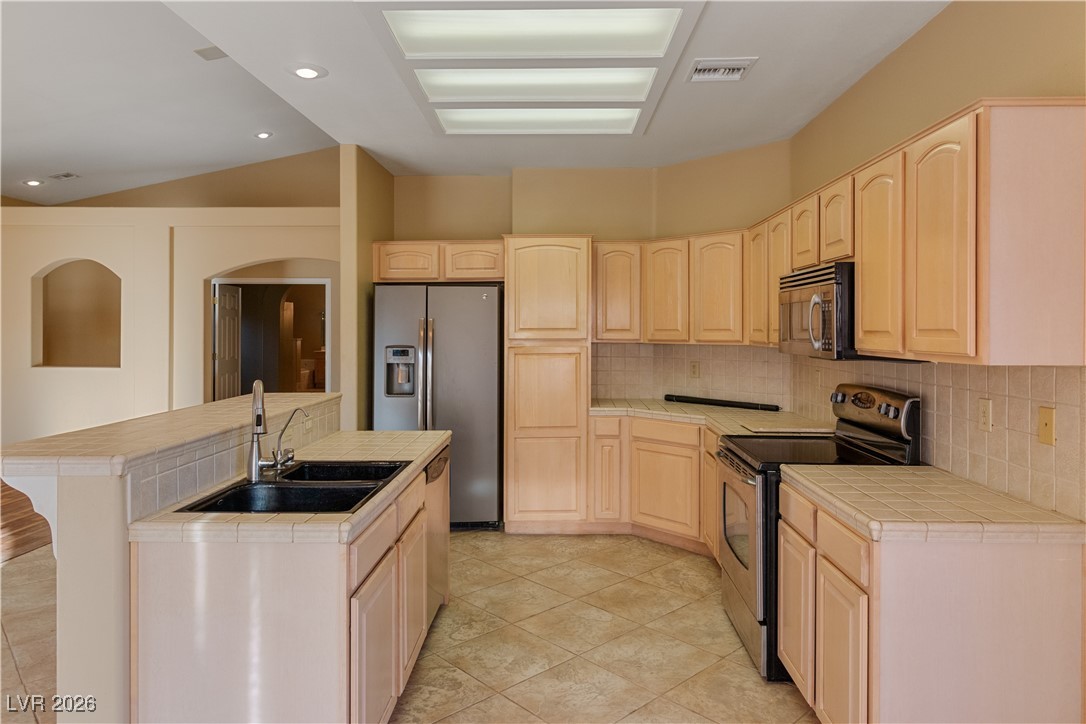 1210 Country Club Drive Laughlin, NV 89029 - Photo 9 of 80 Kitchen with tile countertops, appliances with stainless steel finishes, light brown cabinetry, and recessed lighting