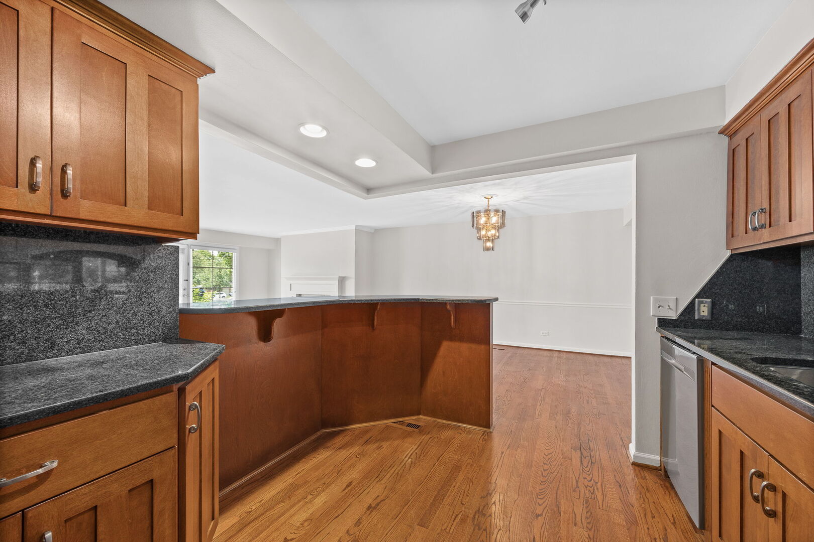 124 Carriage Way Drive, Unit B109 Burr Ridge, IL 60527 - Photo 9 of 31 a kitchen with granite countertop a stove top oven a sink dishwasher and cabinets with wooden floor