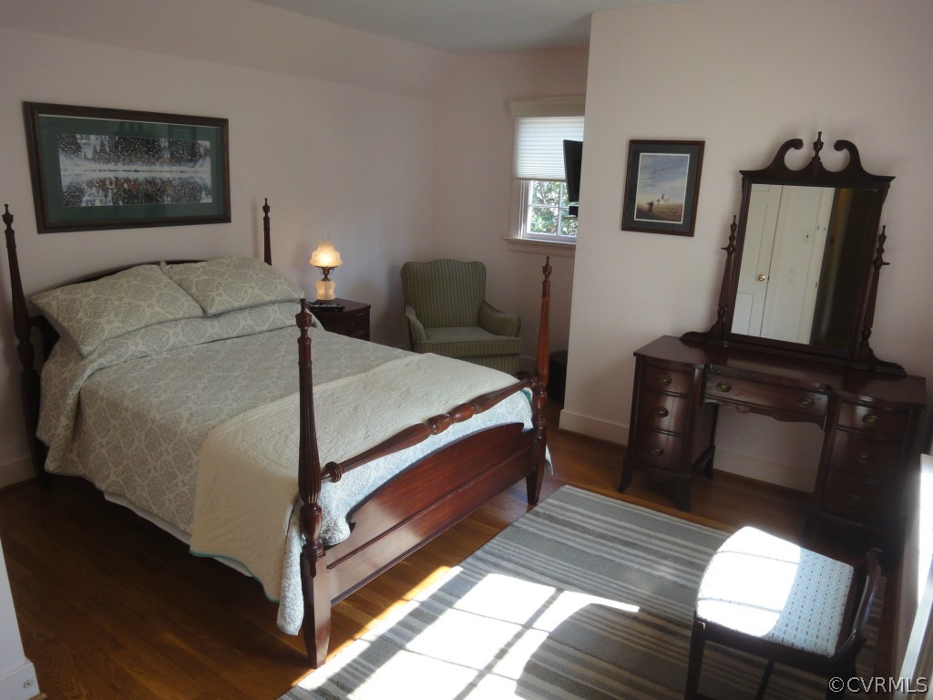 2716 East Brigstock Road Midlothian, VA 23113 - Photo 13 of 24 a bedroom with a bed wooden floor and lamp