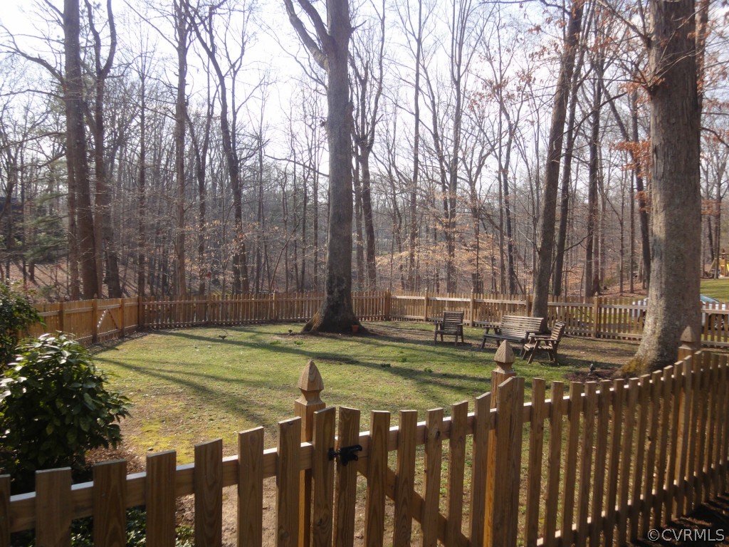 2716 East Brigstock Road Midlothian, VA 23113 - Photo 20 of 24 a view of a backyard with wooden fence