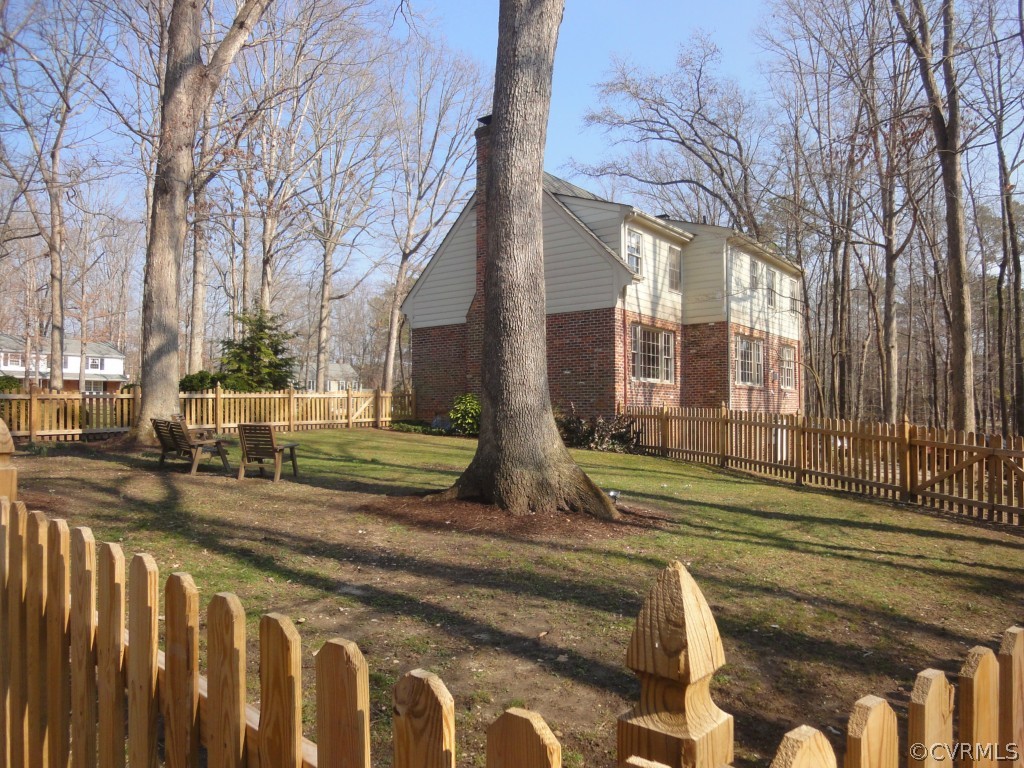 2716 East Brigstock Road Midlothian, VA 23113 - Photo 21 of 24 a view of a brick building next to a yard