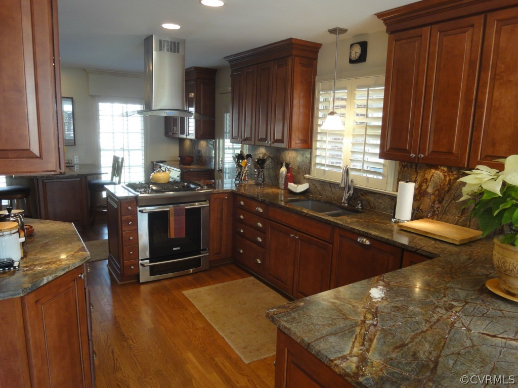 2716 East Brigstock Road Midlothian, VA 23113 - Photo 5 of 24 a kitchen with stainless steel appliances granite countertop a sink stove and cabinets