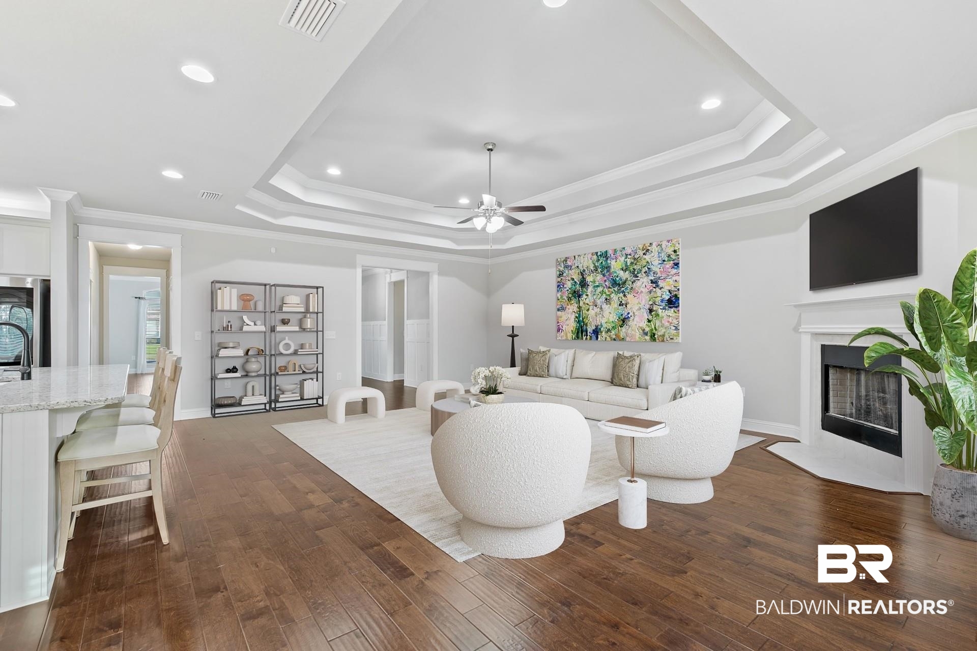31625 Spoonbill Road Daphne, AL 36527 - Photo 18 of 49 Living room with ornamental molding, a raised ceiling, dark wood-type flooring, ceiling fan, and a premium fireplace