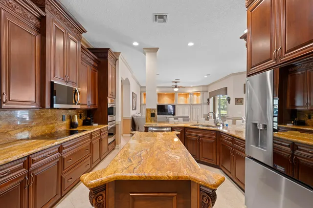 a kitchen with lots of counter top space and stainless steel appliances