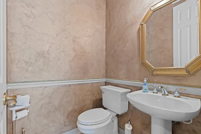 a bathroom with a sink a toilet and mirror