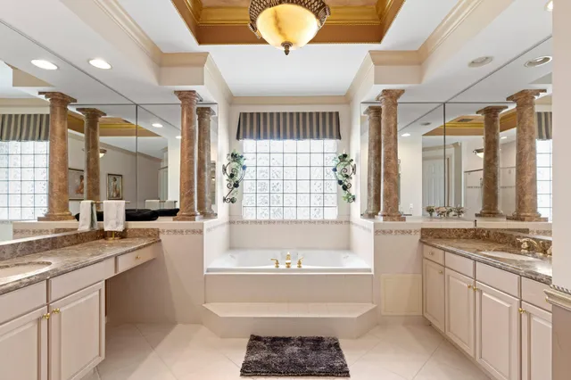 a spacious bathroom with a granite countertop tub sink and mirror